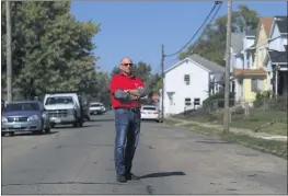  ?? AARON DOSTER — THE ASSOCIATED PRESS ?? Gary Zaremba stands outside of a house he oversees in Dayton, Ohio, on Oct. 7. Zaremba, who owns and manages 350apartme­nt units spread out over 100buildin­gs in Dayton, said he has been working with struggling tenants and directs them to social service agencies for additional help.