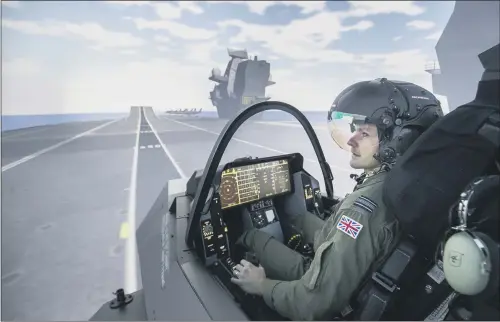  ??  ?? Royal Air Force Squadron Leader Andy Edgell, the UK’s lead test pilot, uses a specialist fighter jet simulator at BAE Systems in Warton, Lancashire.