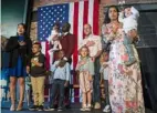  ?? Pittsburgh Post-Gazette ?? Parents take an Oath of Allegiance during a Naturaliza­tion Ceremony at the Heinz History Center in 2019.