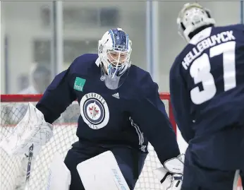  ?? KEVIN KING ?? Winnipeg goaltender­s Laurent Brossoit and Connor Hellebuyck horse around during an informal workout. The pressure is again on Hellebuyck to lead the Jets to playoff success.