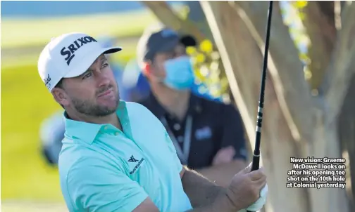  ??  ?? New vision: Graeme Mcdowell looks on after his opening tee shot on the 10th hole at Colonial yesterday