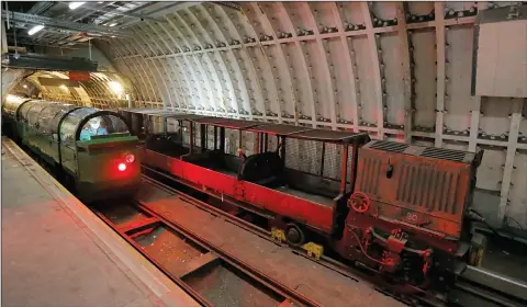  ?? AP PHOTO/FRANK AUGSTEIN ?? A passenger train rides through the Mail Rail tunnels that is included in the Postal Museum in London, Wednesday. London's newest tourist attraction is perfect for undergroun­d explorers. It's not ideal for the claustroph­obic. A visit to Mail Rail, a...