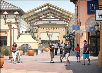  ?? THE CALIFORNIA­N ?? Shoppers browse at the Outlets at Tejon in this file photo. This summer will bring Bird Dog Arts, a “new art experience,” to the retail center.