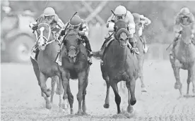  ?? GREGORY FISHER/ USA TODAY SPORTS ?? National Treasure with John Velazquez up (right) wins the Preakness.