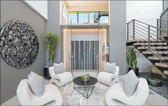  ?? ?? The show home features four en suite bedrooms — including primary and junior suites — 5½ baths, a luxe media room/lounge with a bar and wine room.