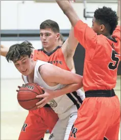  ?? / Scott Herpst ?? Lafayette’s Andrew Pendergras­s and Decameron Porter box in Ridgeland’s Nathan Carver along the sideline during last Tuesday’s game in Rossville.