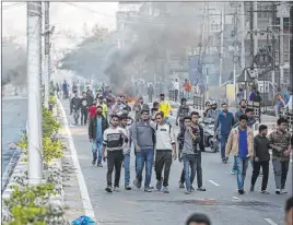  ?? Anupam Nath The Associated Press ?? Protesters defy curfew Thursday in Gauhati, India. Soldiers were patrolling districts struck by violent protests, according to state police chief Bhaskar Mahanta.