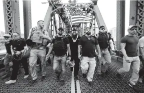  ?? NOAH BERGER/AP ?? Members of the Proud Boys, including organizer Joe Biggs, third from right, march in Portland, Ore., in 2019. Biggs faces federal charges linked to the Jan. 6 riot.