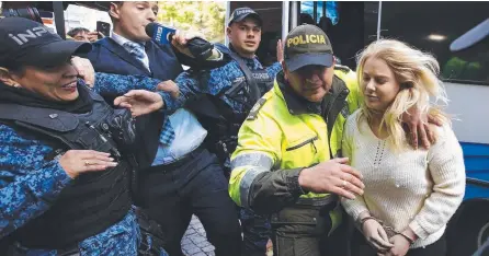  ?? Picture: AP ?? Adelaide woman Cassandra Sainsbury arrives at court in Bogotta in handcuffs.