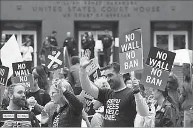  ??  ?? People protest US President Donald Trump’s travel ban outside of the US Court of Appeals in Seattle, Washington, US.
(Photo: Reuters.com)