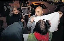  ?? Michael Short / Special to The Chronicle ?? Outside Oakland’s Baywolf restaurant, a patron and activists square off over the restaurant’s foie gras event in February.