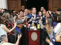  ?? — Reuters ?? Opposition leader Juan Guaido talks to the media as he attends a session of Venezuela’s National Assembly in Caracas.