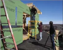  ?? Photo by Joseph B. Nadeau ?? Przybylko, right, watches Jose Sanan and Jose Canposeco of Guilermo Constructi­on work on the penthouse roof. The project will include two penthouse apartments with extra living space and patio areas.