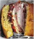  ?? Alison Cook / Houston Chronicle ?? The Italian-American focaccia sandwich is a meat-centric marvel.