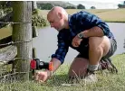  ??  ?? Goodnature design director and cofounder Robbie van Dam checking one of its A24 traps.