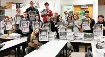  ?? MILLARD WEST YEARBOOK STAFF ?? Students at Millard West High School in Omaha hold up their student newspaper, which won a state award after overcoming censorship of a column that criticised teachers for bringing their own politics into the classroom.