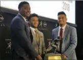  ?? RALPH RUSSO — THE ASSOCIATED PRESS ?? Heisman Trophy finalists, from left, Dwayne Haskins, from Ohio State, Kyler Murray, of Oklahoma, and Tua Tagovailoa, from Alabama, pose with the Heisman Trophy at the New York Stock Exchange on Friday.