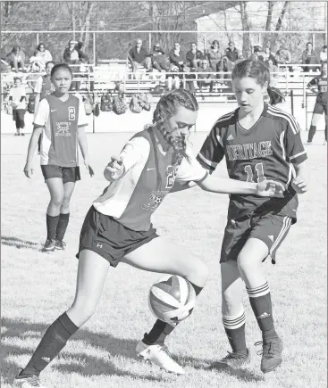  ??  ?? Lakeview’s Gracie Cochran tries to shield the ball from Heritage’s Mady Terry (11) during last week’s NGAC match at Lakeview. The Lady Generals collected a 4-0 win. (Photo by Scott Herpst)