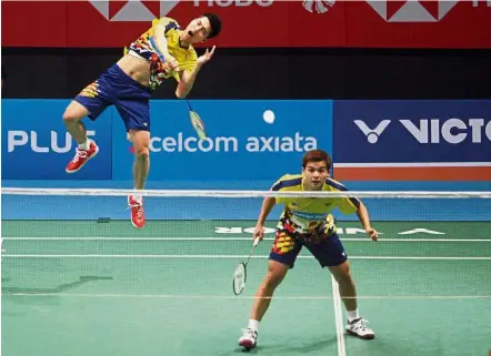  ??  ?? Smashing form: Malaysia’s Ong Yew Sin (left) and Teo Ee Yi in action against Denmark’s Mathias Boe- Carsten Mogensen in the first round of the men’s doubles event. The Malaysians upset the world No. 3 pair with a 21-17, 18-21, 21-13 victory yesterday.