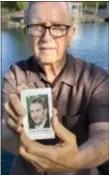  ?? ANDREW FOULK — THE ORANGE COUNTY REGISTER VIA AP ?? In this Friday photo, Frank Kerrigan holds onto a a funeral card for his son Frank, near Wildomar Kerrigan, who thought his son had died, learned he buried the wrong man.