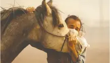  ?? RINGO H.W. CHIU / THE ASSOCIATED PRESS ?? Fabio Losurdo comforts his horse, Smarty, at a ranch in Simi Valley, Calif., north of Los Angeles, on Wednesday.