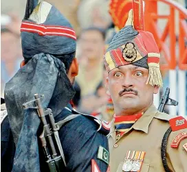  ?? — AP ?? A Border Security Force soldier, right, and a Pakistani Rangers soldier face each other at a daily closing ceremony at the Wagah border post near Lahore, Pakistan.