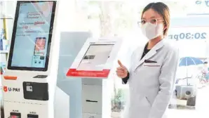  ?? ?? Prudential Cambodia and PillTech are installing insurance selling machines in pharmacies.