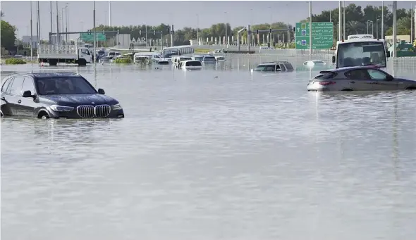  ?? Photo: AP ?? Vehicles sit abandoned in floodwater covering a major road in Dubai United Arab Emirates on April 17, 2024.