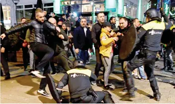  ??  ?? Flashpoint: Dutch riot police clashing with protesters in Rotterdam yesterday