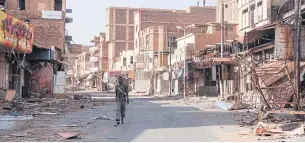  ?? REUTERS ?? A soldier walks past the ruins of buildings in Omdurman, almost one year into the war between the Sudanese Armed Forces and the paramilita­ry Rapid Support Forces (RSF).