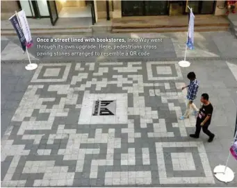  ??  ?? Once a street lined with bookstores, Inno Way went through its own upgrade. Here, pedestrian­s cross paving stones arranged to resemble a QR code