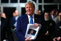 ?? AFP PHOTO ?? NO COVER-UP
Former US president Donald Trump holds news clippings during his trial for allegedly covering up hush money payments linked to extramarit­al affairs at Manhattan Criminal Court in New York City on Thursday, April 18, 2024.