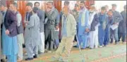  ?? AP ?? Afghan men line up to cast their votes, inside a polling station during the Parliament­ary election in Kabul on Saturday.