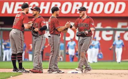  ?? CHARLIE RIEDEL/AP ?? Diamondbac­ks players celebrate after their victory over the Royals on Sunday in Kansas City, Mo.