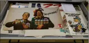  ??  ?? „ Archivist Laura Burchell, top, holds 70s beer poster with Morecambe and Wise; examples of festive brews.