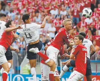  ?? Matthias Schrader, The Associated Press ?? Denmark’s Simon Kjaer, fourth from the left, heads the ball during Tuesday’s World Cup match against France in Moscow.