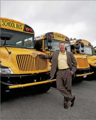  ?? DIGITAL FIRST MEDIA FILE PHOTO ?? In this file photo, Blake Krapf, president and CEO of Krapf Bus Companies, stands in front of some of his company’s buses. Krapf has purchased Birnie Bus of central New York.