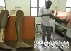  ??  ?? A technician checks finished prosthetic limbs at the ICRC- run physical rehabilita­tion centre in Juba. — AFP photo