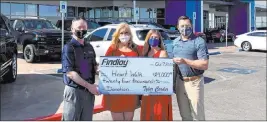  ?? Findlay ?? Findlay Automotive Group CFO Tyler Corder, left, and Findlay Chevrolet General Manager Doug Fleming, right, present a check for $24,000 to Debbie Smith, executive director of American Heart Associatio­n, and Kelley Grim, director of business developmen­t of American Heart Associatio­n.