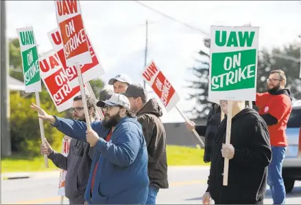  ?? STEVE RUARK AP ?? Members of UAW Local 171 picket outside a Mack Trucks facility in Hagerstown, Md., after going on strike Monday. With Mack Trucks workers joining picket lines, the total number of UAW members that are on strike now exceeds 30,000 across 22 states, the union said.