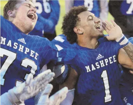  ?? STAFF PHOTO BY JOHN WILCOX ?? LET ’EM HEAR IT: Mashpee’s John McNamara and Devaun Ford celebrate with their team after beating St. Mary’s to clinch a spot in the Division 7 Super Bowl yesterday at Braintree High.