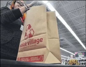  ?? SARA ERICSSON/SALTWIRE NETWORK ?? Value Village store manager Reg Chitty says the store branch has been using paper bags in lieu of plastic since August, and the change has been a popular one with customers.