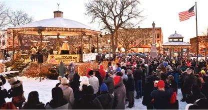  ?? ?? Revelers gather at the gazebo to celebrate the 30th anniversar­y of the film “Groundhog Day” in Woodstock.