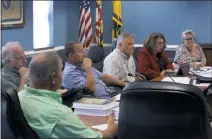  ?? STAFF PHOTO BY PAUL LAGASSE ?? Michael Sullivan, left, Russel Shlagel (back to camera), Ray Curtis, Tim Lessner, Bonnie Hochman Rothell and Brianna Bowling of the Charles County Rural Planning and Zoning Task Force discuss items to be included on their list of recommenda­tions to the county commission­ers during their last meeting in September.