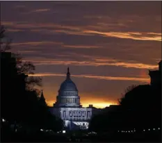  ?? PHOTO/JOHN MINCHILLO ?? In this an. 20, 2017 file photo, the U.S. Capitol Building is illuminate­d during sunrise in Washington. AP