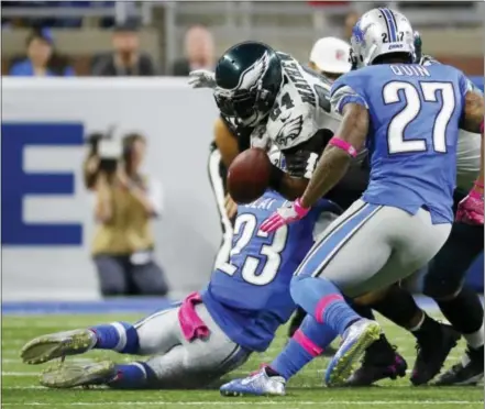  ?? RICK OSENTOSKI — THE ASSOCIATED PRESS ?? Detroit Lions cornerback Darius Slay (23) hits Philadelph­ia Eagles running back Ryan Mathews and forces a fumble during the second half of an NFL football game, Sunday in Detroit.