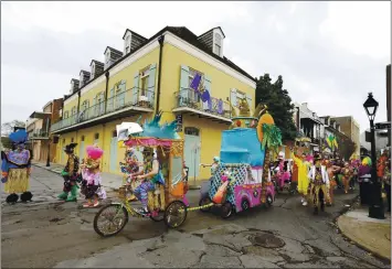  ?? PHOTOS BY RUSTY COSTANZ — THE ASSOCIATED PRESS ?? Mondo Kayo parades down Chartres Street during Mardi Gras in New Orleans in February 2020.