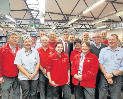  ??  ?? Postal workers in Macclesfie­ld meet MP David Rutley ahead of the Christmas rush