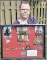  ?? ADAM MACINNIS/SALTWIRE NETWORK ?? Rob Rushton holds a case displaying some of his father’s medals as well as a piece of metal that was removed posthumous­ly from his dad’s leg. It had lodged there during a battle in the Second World War.