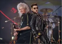  ?? CHRIS PIZZELLO, THE ASSOCIATED PRESS ?? Brian May of Queen, left, and Adam Lambert: Since joining forces The American Idol runner-up and the band that ruled rock radio in the 1970s and early ’80s have enjoyed tremendous success touring.